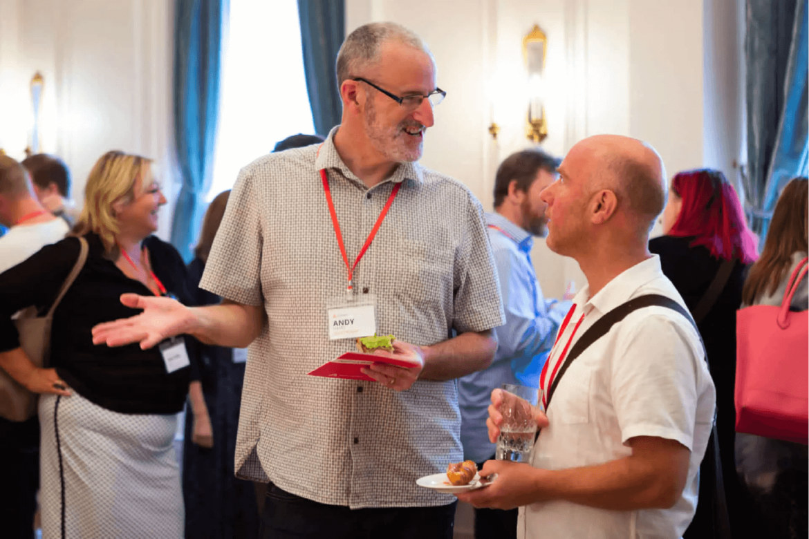 Two people speaking at an Agency Hackers conference