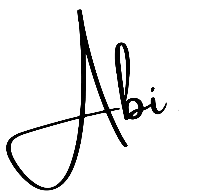 Stylized signature of the name "Abi" in black cursive on a light gray background.