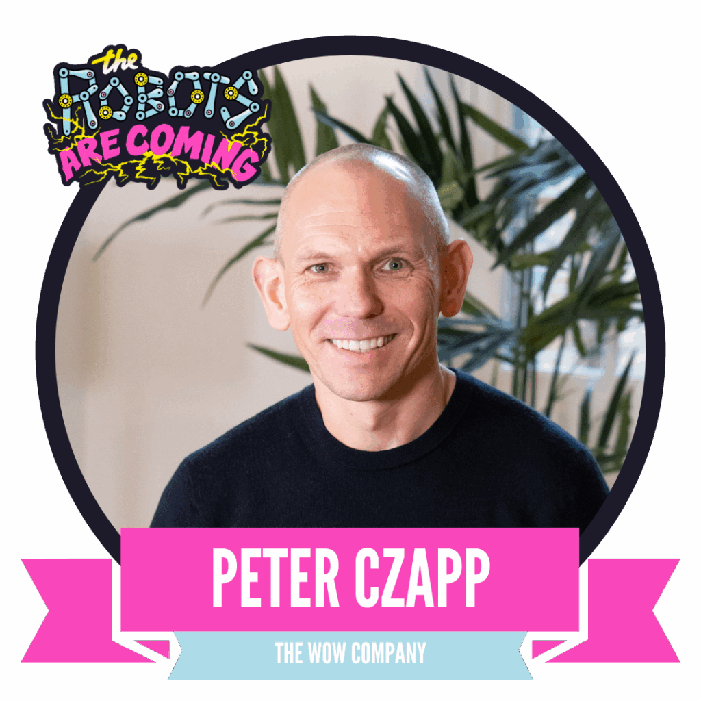A man smiling in a circular portrait with a green leafy background, framed by a banner that reads "The Robots Are Coming" and a pink ribbon displaying "Peter Czapp, The Wow Company."
