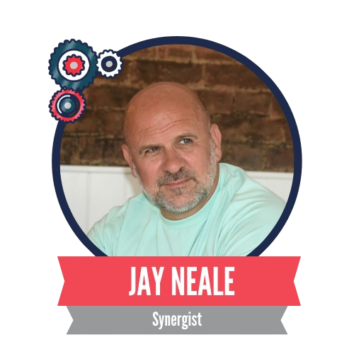 Portrait of a man with a neutral expression against a brick wall, framed with a circular border. The name "Jay Neale" and the title "Synergist" are displayed beneath, with decorative gear icons.