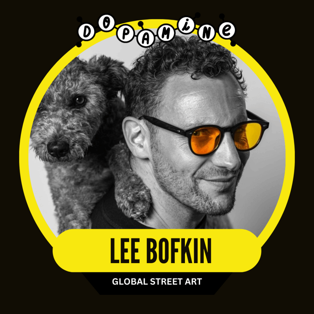 A man wearing sunglasses smiles with a dog resting its head on his shoulder. The image has a black and yellow circular border with text that reads "Lee Bofkin" and "Global Street Art."