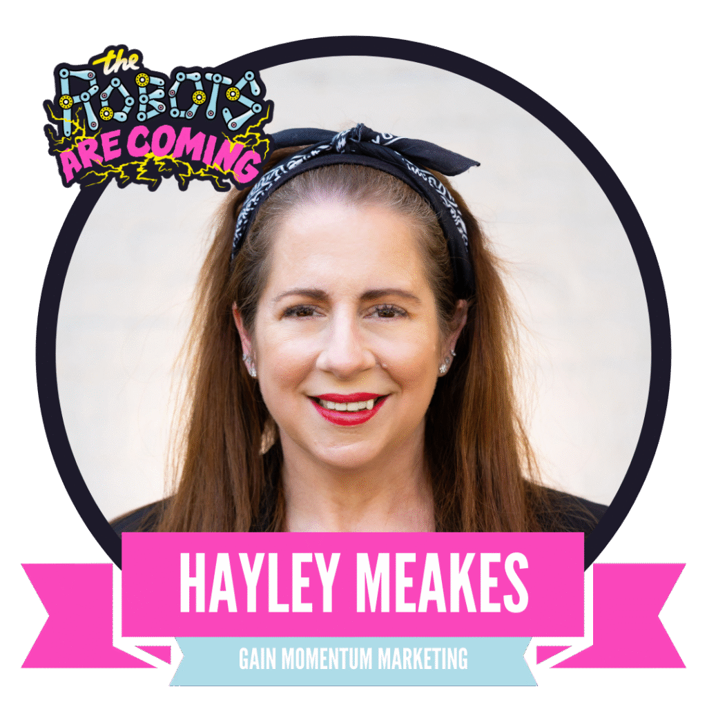 A woman with long brown hair and a black headband smiles at the camera. A banner reads "Hayley Meakes, Gain Momentum Marketing." The image has a playful text above stating "The Robots Are Coming."