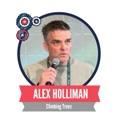 A person speaking into a microphone against a tiled background, with a banner displaying the name "Alex Holliman" and the phrase "Climbing Trees."