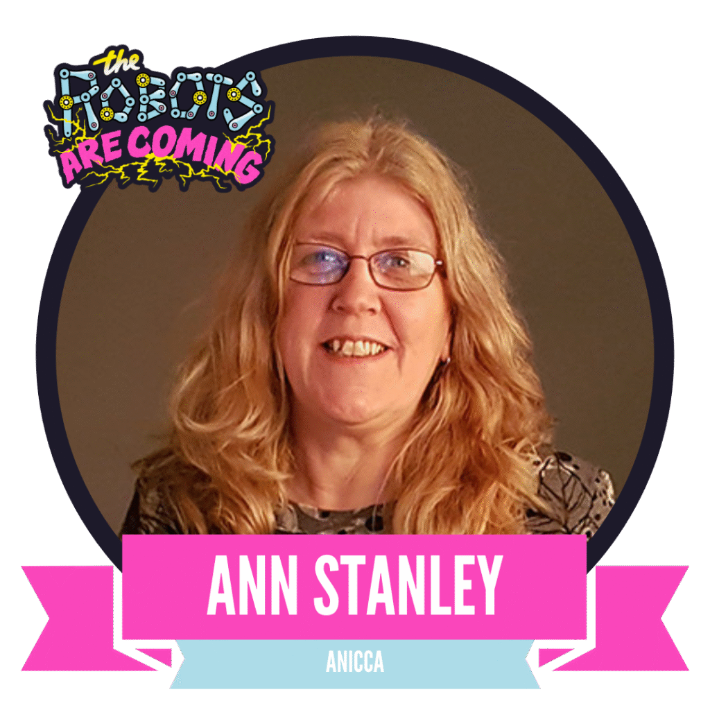 A woman with long blonde hair and glasses smiles at the camera. A banner reads "The Robots Are Coming," with her name displayed below.