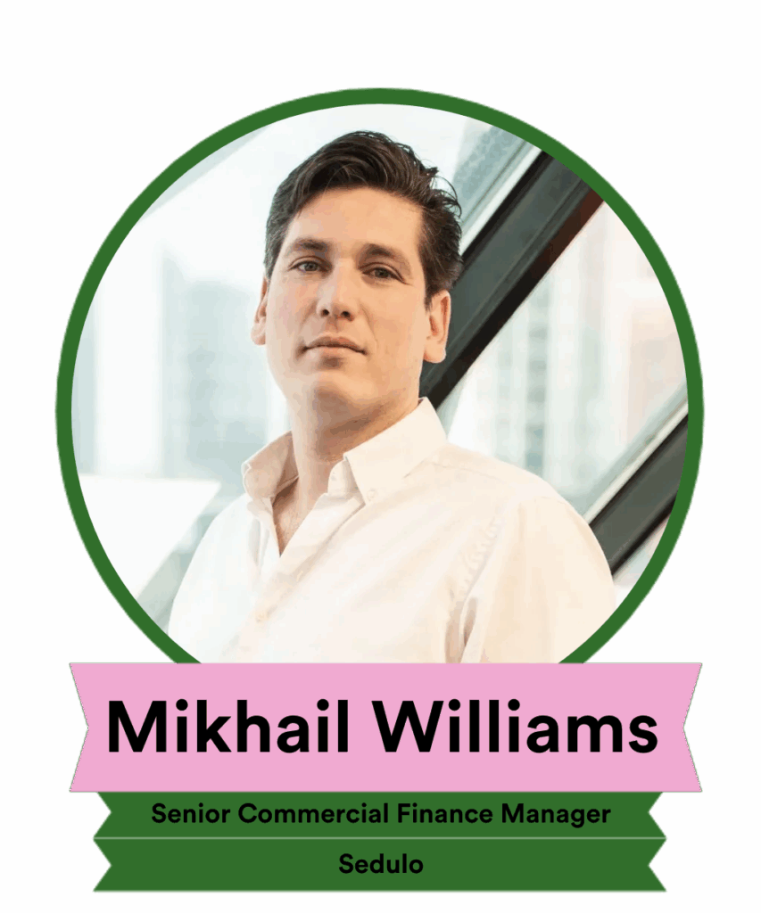 Portrait of Mikhail Williams, a Senior Commercial Finance Manager at Sedulo, standing next to a window with a cityscape in the background. He has a neutral expression and is dressed in a light-colored shirt. The image features a circular border and his name and title at the bottom.