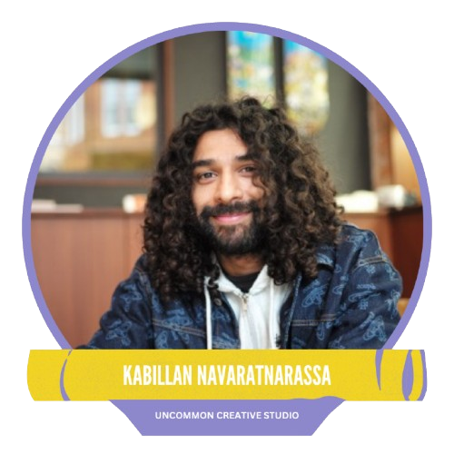 A person with long, curly hair and a beard smiles at the camera, wearing a patterned jacket indoors. The yellow nameplate reads "Kabillan Navaratnarassa" from Uncommon Creative Studio.