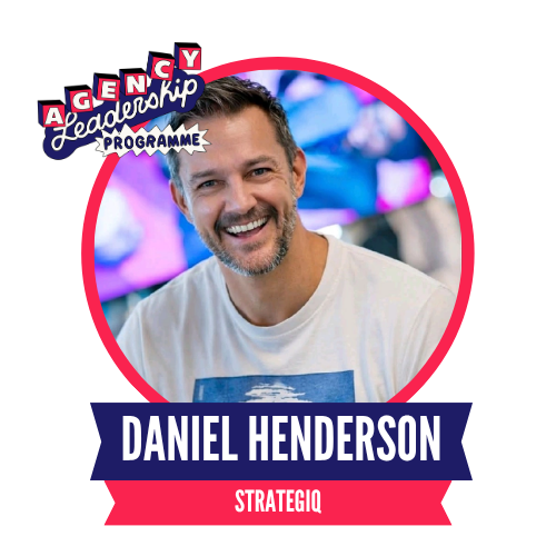 Man smiling, wearing a white t-shirt with text "Daniel Henderson" and "StrategiQ" displayed in a colorful circular badge design, labeled "Agency Leadership Programme."
